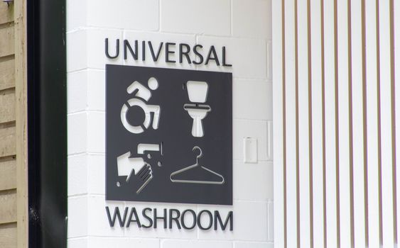 Universal bathroom or washroom sign in a public park in Canada. A controversial topic surrounding transgender rights and issues.