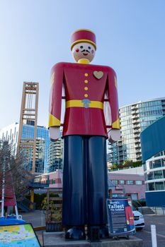 "New Westminster, British Columbia/Canada - 8/3/2019: On the Quay, a Statue of the world's tallest tin solder along the boardwalk in the evening summer sun."
