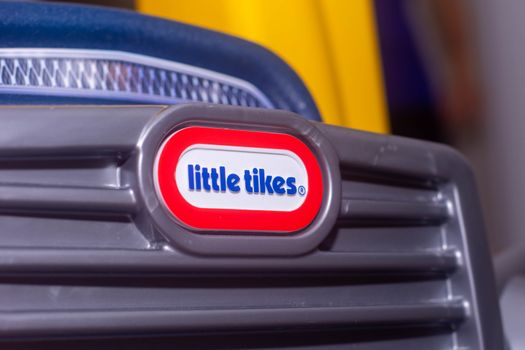 "Brighton, Ontario/Canada - 07/22/2019: Little tikes logo on a child's toy bightly coloured car."