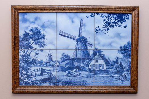 Six Delft Blue tiles in a frame, a souvenir from Holland/Netherlands. hanging on a wall making a windmill and typical farm scene.