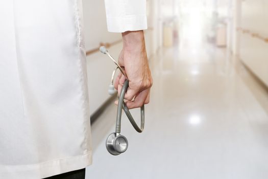 doctor's hand holding stethoscope in the hospital