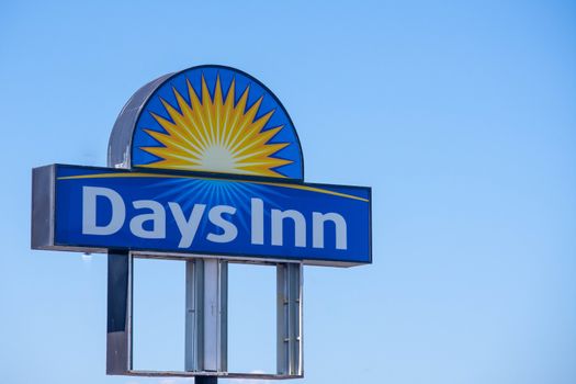 "Kelowna, British Columbia/Canada - 07/29/2019: Days Inn  Hotel Sign on blue sky sunny day with copy space."