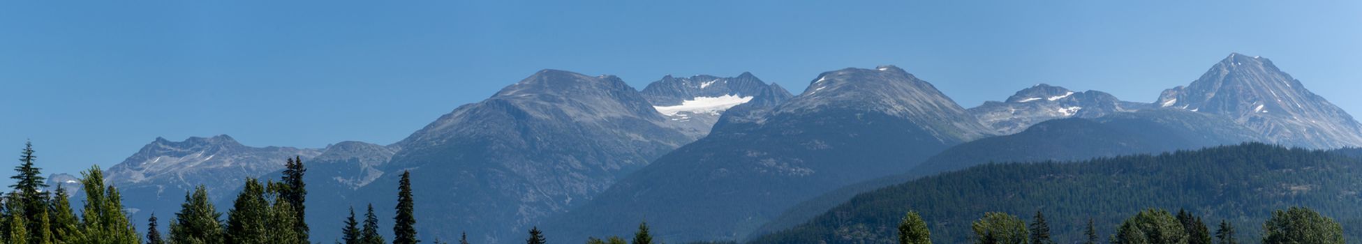Whistler Mountain Panorama in British Columbia, Canada in the summer sun and blue sky looking at mountain range