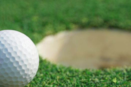 close-up on a golf ball on lip of cup