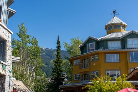 Whistler Mountain in British Columbia, Canada looking to the summer ski lifts and Gondola at Blackcomb and the village accommodations on a sunny day.