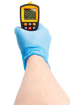 Right caucasian hand in blue medical latex glove aiming with yellow infrared contactless thermometer isolated on white background, mockup display state with all symbols on. First person view, gonzo perspective.