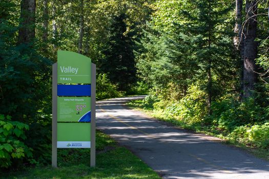 "Whistler, British Columbia/Canada - 08/07/2019: Valley Trail Sign in Whistler, British Columbia, Canada in the summer for biking, walking, running, rollerblading enjoying nature on the way to Whistler Village."