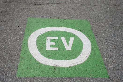 Electric vehicle green parking place for e-cars saving the environment from fuel and gas use.