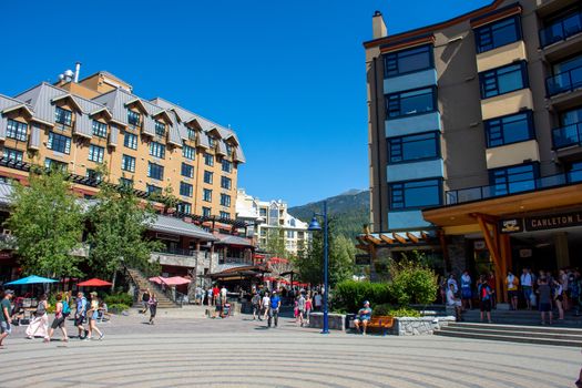 "Whistler, British Columbia/Canada - 08/07/2019: Carleton Lodge in Whistler village outside streets during the summer looking at the walkway, street, shops, hotels, and tourists enjoying this Olympic world class destination."