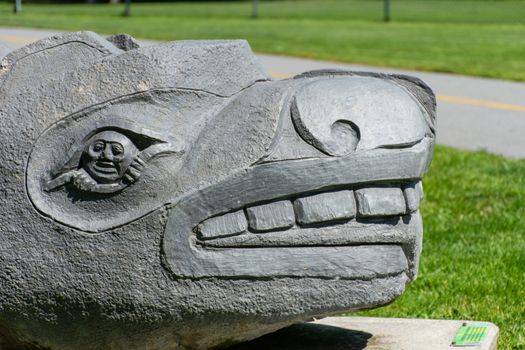 "Whistler, British Columbia/Canada - 08/07/2019: Close up of the Whistler Grandfather Bear First Nations Art statue in Meadow Park in the summer sun"