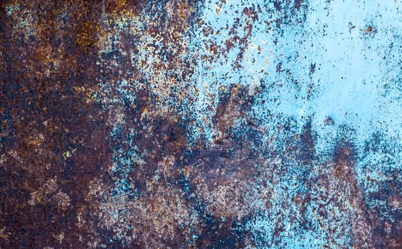 Rusty metallic texture. Oxidation of the metal. Grunge, steampunk, rock, vintage. Iron background, brown, red and blue.