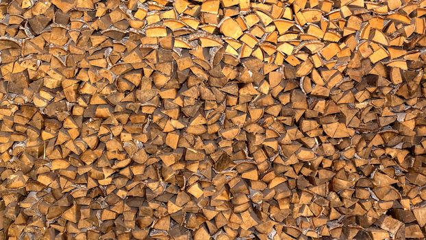 Pile of firewood for the fireplace, oven. A wall of stacks. Log, timber, fire, texture,
