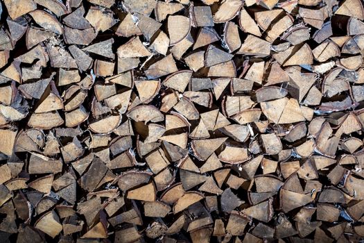 Pile of firewood for the fireplace, oven. A wall of stacks. Log, timber, fire, texture,