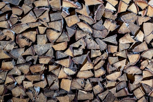 Pile of firewood for the fireplace, oven. A wall of stacks. Log, timber, fire, texture,