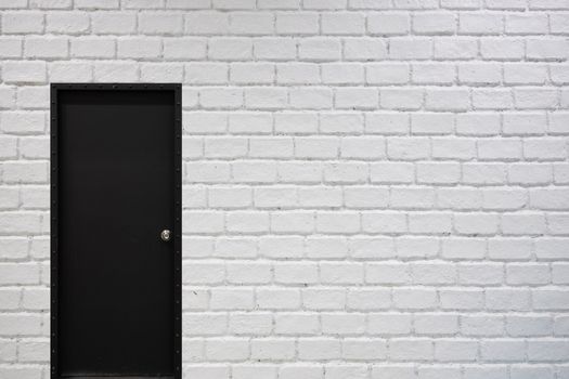 white brick wall background with black door for architecture and interior design mockup