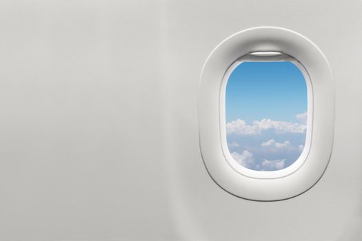 Isolated airplane window with blue sky from customer seat view