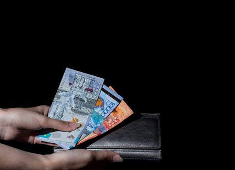 Hold wallet with money in hand. Tenge KZT. National currency of Kazakhstan, KZ. Exchange rate. Economy, development, business, Bank, broker.