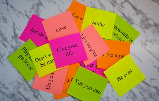 Motivational words on colorful stickers on a marble table. Business plan, strategy, concept, future. Copy space, creativity, project, art. Vision board.