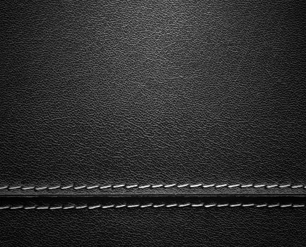 Real close-up of black leather background texture with horizontal stitch.