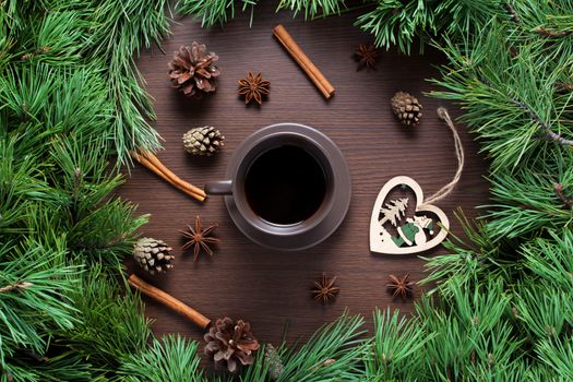 Christmas composition. A Cup of coffee, cones and Christmas toys on a wooden background. The decoration of Christmas wreaths. Winter, new year concept. Flat lay, top view