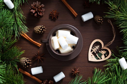 Christmas composition. A Cup of coffee, cones and Christmas toys on a wooden background. The decoration of Christmas wreaths. Winter, new year concept. Flat lay, top view. Marshmallow