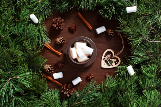 Christmas composition. A Cup of coffee, cones and Christmas toys on a wooden background. The decoration of Christmas wreaths. Winter, new year concept. Flat lay, top view. Marshmallow. 2020