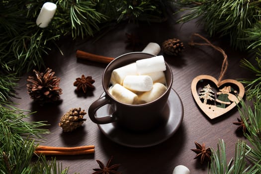 Christmas composition. A Cup of coffee, cones and Christmas toys on a wooden background. The decoration of Christmas wreaths. Winter, new year concept. Flat lay, top view. Marshmallow. 2020
