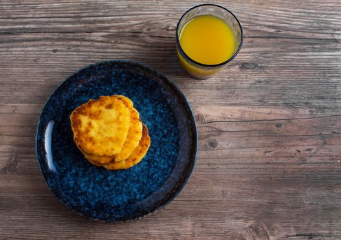 Breakfast, food. Pancakes on a blue plate and orange juice. Homemade food, simple recipe. A healthy life style. Flat lay. Luxury decor.