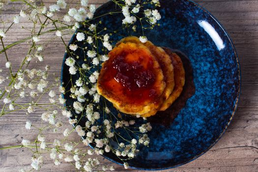 Beautiful Breakfast. Food. Pancakes with strawberry jam. Flowers and stylish dishes. A healthy life style. Flat lay. Luxury decor. Lunch, snack. Family meal. Home cooking.