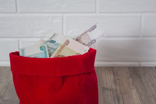 Russian rubles in a red bag. Full bag of money. Banknote, currency, Bank, business, economy, investment. Salary, winnings, prize, stash,