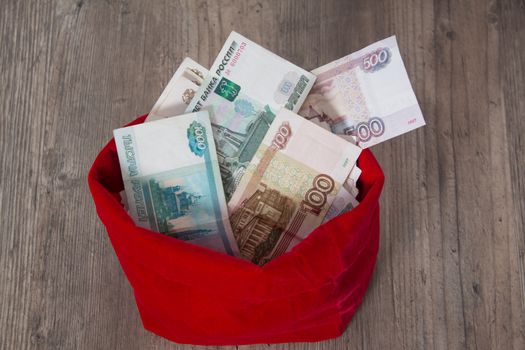 Russian rubles in a red bag. Full bag of money. Banknote, currency, Bank, business, economy, investment. Salary, winnings, prize, stash,