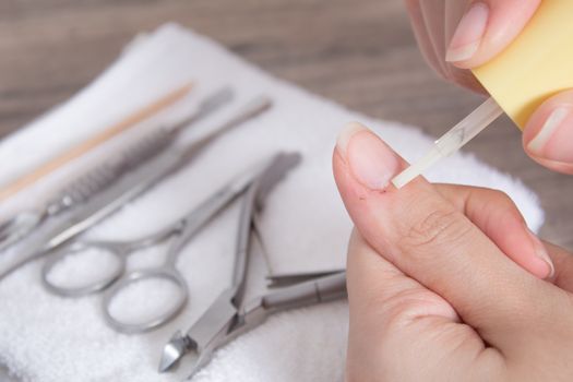 Apply oil to the cuticle. The wound after a manicure. A scratch, a cut. Manicure, nail care. Nail salon, procedure, SPA. Home nail care. Manicure tools. Beauty, lifestyle