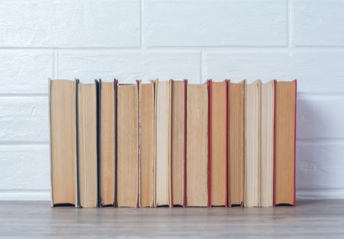 Hardcover books in close-up. Bookshelf, bookstore, library. The background of the books. Multicolored covers. Reading, education, study. Retro, vintage, old.
