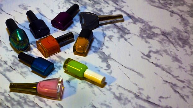 Scattered nail Polish in the beauty salon. The choice of color nail Polish for manicure or pedicure. gel Polish for manicure on a marble table.