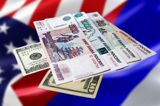 Russian and American money on an abstract background. The Russian ruble on the us dollar against the flags of America and Russia.