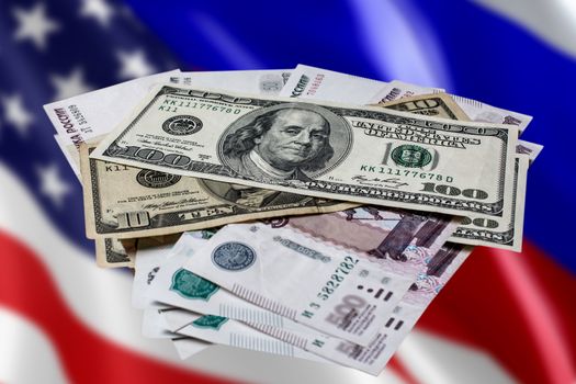 Us dollars and Russian rubles on an abstract background. The Russian ruble against the us dollar against the flags of America and Russia.