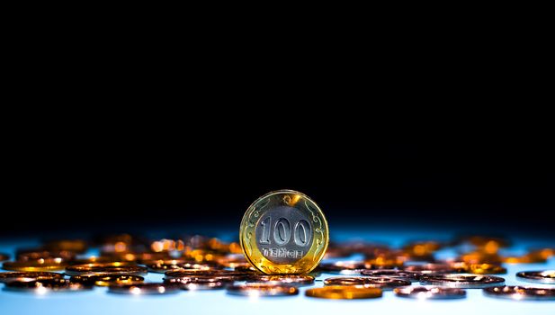 Tenge on a blue background with coins. Tenge coins of Kazakhstan