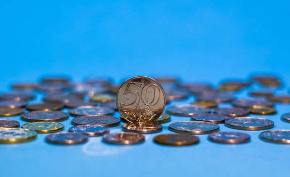 Tenge on a blue background with coins. Tenge coins of Kazakhstan