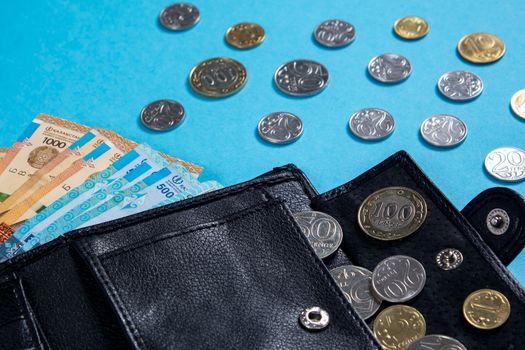 Tenge on blue background with coins. Tenge is the national currency of Kazakhstan. Bank of Kazakhstan