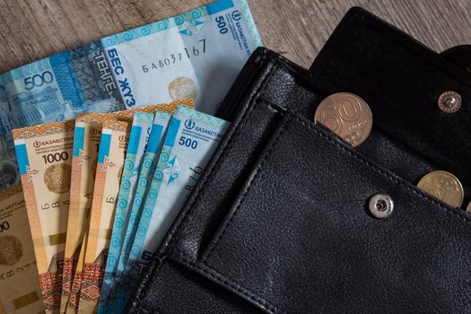 Tenge on wooden background with coins. Tenge is the national currency of Kazakhstan. bank of Kazakhstan