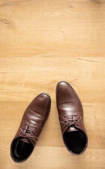 brown man leather shoe on wooden background