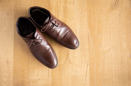 brown man leather shoe on wooden background