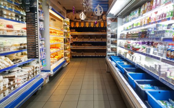 Nursultan,Kazakhstan,november.22.19. Food stands in the supermarket.A grocery store with shelves of food.Provisions,dairy products,bread,cheese,yogurt and sweets are on the shelf in the grocery mall