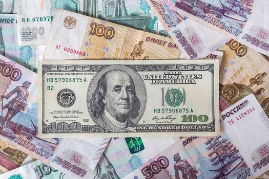 Paper banknotes of Russian rubles and the us dollar.100 Dollars on Russian rubles. Rubles are the national currency of Russia. bank of Russia.The growth of the ruble