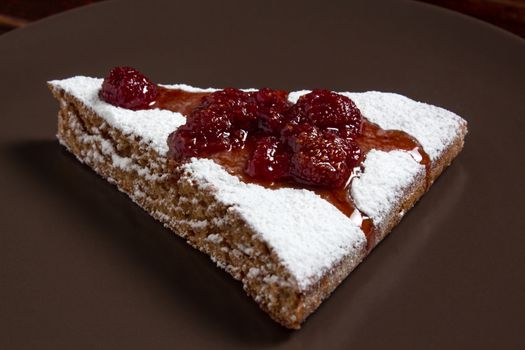 A piece of cake with strawberry jam and sugar. Dessert, food, sweet, baking. Biscuit, brownie, tiramisu, cheesecake. Cook at home, homemade, closeup, Bakery products.