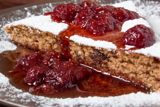 A piece of cake with strawberry jam and sugar. Dessert, food, sweet, baking. Biscuit, brownie, tiramisu, cheesecake. Cook at home, homemade, closeup, Bakery products.