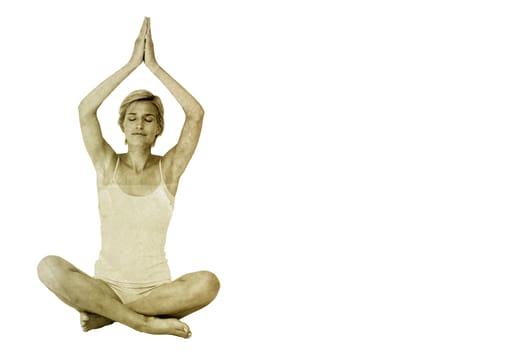 Fit woman doing yoga against yellow leaf