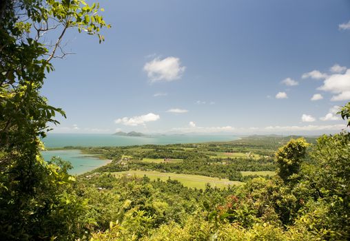 View over the coast and Mission Beach, Queensland, Australia in a lush green tropical landscape from an elevated viewpoint