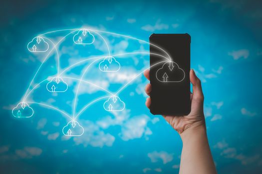 Hand holding smartphone with cloud icon on blurry blue sky background. Communication of business and financial. Cloud data storage concept.