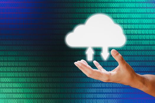 Hand holding white cloud storage computing icon on blue and green binary code background. Communication of business and financial. Cloud data storage concept.